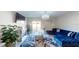 Living room with blue sectional sofa, fireplace, and sliding glass doors at 10251 Carloway Hills Dr, Wimauma, FL 33598