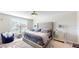 Main bedroom with plush bed and mirrored nightstands at 10251 Carloway Hills Dr, Wimauma, FL 33598