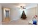 Spacious upstairs sitting area with Christmas tree and large window at 10251 Carloway Hills Dr, Wimauma, FL 33598