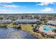 Aerial view of a waterfront community with a pool and lush landscaping at 107 Seahorse Se Dr # A, St Petersburg, FL 33705