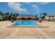 Refreshing community pool with brick patio and lounge area at 107 Seahorse Se Dr # A, St Petersburg, FL 33705