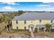 Exterior view of a yellow building with palm trees and a walkway at 107 Seahorse Se Dr # A, St Petersburg, FL 33705