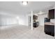 Modern kitchen with dark cabinets, granite counters, and stainless steel appliances at 107 Seahorse Se Dr # A, St Petersburg, FL 33705