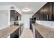 Modern kitchen with dark cabinets and granite countertops at 107 Seahorse Se Dr # A, St Petersburg, FL 33705