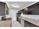 Modern kitchen with dark cabinets, granite counters, and stainless steel appliances at 107 Seahorse Se Dr # A, St Petersburg, FL 33705