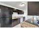 Modern kitchen with dark cabinets and granite countertops at 107 Seahorse Se Dr # A, St Petersburg, FL 33705