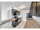 Dark wood cabinets, granite countertops, and stainless steel appliances in this galley kitchen at 107 Seahorse Se Dr # A, St Petersburg, FL 33705