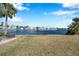 Serene lake view with a bench, green grass and palm trees at 107 Seahorse Se Dr # A, St Petersburg, FL 33705