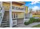 Ground level patio, stairs to second floor balcony, and fenced yard at 107 Seahorse Se Dr # A, St Petersburg, FL 33705