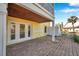 Ground level patio with brick flooring and French doors at 107 Seahorse Se Dr # A, St Petersburg, FL 33705