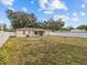 Spacious backyard with view of house and fence at 10930 N Edison Ave, Tampa, FL 33612