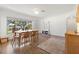 Bright dining room features hardwood floors, a wood dining table with chairs, and large window at 112 K St, Clearwater, FL 33759