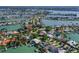 Aerial view of a waterfront property with lush landscaping and nearby canals at 1200 80Th S St, St Petersburg, FL 33707