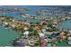An aerial view showcasing a waterfront home in a tranquil, residential community at 1200 80Th S St, St Petersburg, FL 33707