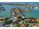 An aerial view of a house on the water, surrounded by other houses and waterways at 1200 80Th S St, St Petersburg, FL 33707