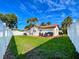 Large backyard with grassy lawn and white fence at 1200 80Th S St, St Petersburg, FL 33707