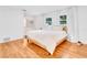 Light and airy bedroom with hardwood floors and a king-size bed at 1200 80Th S St, St Petersburg, FL 33707