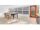 Sunlit dining room with large windows and stylish table at 1200 80Th S St, St Petersburg, FL 33707