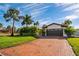 Single story home with brick driveway and lush landscaping at 1200 80Th S St, St Petersburg, FL 33707