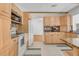 Kitchen with light wood cabinets, granite counters and tile floors at 1200 80Th S St, St Petersburg, FL 33707