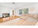 Bright living room with hardwood floors and comfy sectional sofa at 1200 80Th S St, St Petersburg, FL 33707