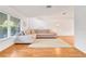 Living room with hardwood floors, sectional sofa, and large window at 1200 80Th S St, St Petersburg, FL 33707