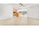 Bright living room with hardwood floors and a view into the kitchen at 1200 80Th S St, St Petersburg, FL 33707