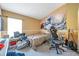 Spacious bedroom with a bed, gaming chair and musical instruments at 12308 Adventure Dr, Riverview, FL 33579