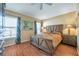 Bright bedroom featuring wood floors and large bed at 12308 Adventure Dr, Riverview, FL 33579