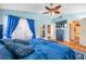 Blue bedroom with king bed and ensuite bathroom at 12308 Adventure Dr, Riverview, FL 33579