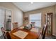 Bright dining room with wood table and chairs, adjacent to laundry area at 12308 Adventure Dr, Riverview, FL 33579