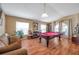 Game room with pool table, hardwood floors, and ample natural light at 12308 Adventure Dr, Riverview, FL 33579