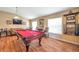 Game room with pool table, hardwood floors, and large windows at 12308 Adventure Dr, Riverview, FL 33579