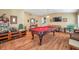 Game room with pool table, entertainment center, and hardwood floors at 12308 Adventure Dr, Riverview, FL 33579