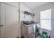 Laundry room with washer, dryer, and shelving at 12308 Adventure Dr, Riverview, FL 33579