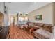 Open living space with L-shaped sofa and view of kitchen and entryway at 12308 Adventure Dr, Riverview, FL 33579