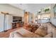 Spacious living room with L-shaped sofa, wood floors, and views into kitchen at 12308 Adventure Dr, Riverview, FL 33579
