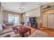 Living area featuring a sectional sofa, coffee table, and pool access at 12308 Adventure Dr, Riverview, FL 33579