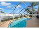 Beautiful screened in pool with patio furniture and a grill at 12308 Adventure Dr, Riverview, FL 33579