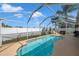 Inviting kidney-shaped pool with screened enclosure, perfect for sunny days at 12308 Adventure Dr, Riverview, FL 33579