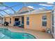 Relaxing screened pool and patio with a blue fireplace at 12308 Adventure Dr, Riverview, FL 33579