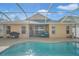 Inviting screened pool area with patio furniture and a grill at 12308 Adventure Dr, Riverview, FL 33579