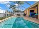 Refreshing screened pool with patio furniture and a grill at 12308 Adventure Dr, Riverview, FL 33579