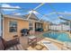 Relaxing pool area with screened enclosure, patio furniture, and a beautiful pool at 12308 Adventure Dr, Riverview, FL 33579