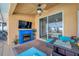 Covered patio with fireplace, comfortable seating, and views of the pool at 12308 Adventure Dr, Riverview, FL 33579