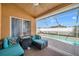 Enjoy the view from this comfortable poolside patio with seating and ceiling fan at 12308 Adventure Dr, Riverview, FL 33579