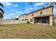 View of the home's backyard, featuring a screened patio at 15406 Peach Stone Pl, Ruskin, FL 33573
