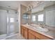 Bathroom boasts dual sinks, a shower, and updated fixtures at 15406 Peach Stone Pl, Ruskin, FL 33573