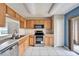 Kitchen with stainless steel appliances and wood cabinets at 15406 Peach Stone Pl, Ruskin, FL 33573