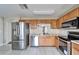 Kitchen with stainless steel appliances and wood cabinets at 15406 Peach Stone Pl, Ruskin, FL 33573